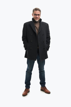 Full length portrait of confident businessman. Happy mid adult, mature age man standing in coat, smiling, isolated on white background.