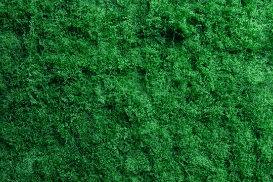 Close up macro shot of a green synthetic fibrous texture.,Concept of cleaning scouring pad background,artificial grass fiber,abstract green moss pattern with blank copy space for design.