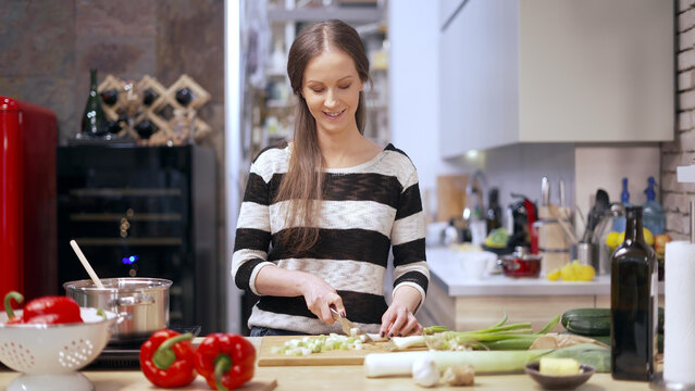 Young woman cooking in kitchen at home, healthy eating.