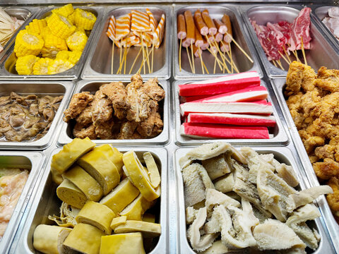 Assorted Wok Ingredients on Display in Asian Restaurant &ndash; Fresh Mushrooms, Greens, Sliced Vegetables, Various Noodles, Glass Noodles, Meatballs, Shrimp and Chicken for Custom Stir-Fry