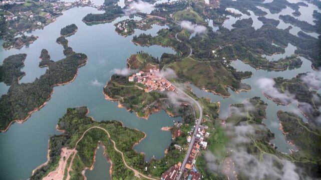 Guatap&eacute; and El Pe&ntilde;&oacute;n de Guatap&eacute; Surrounded by Reservoir Islands in Antioquia, Colombia. Time Lapse. Establishing Shot. Aerial View.