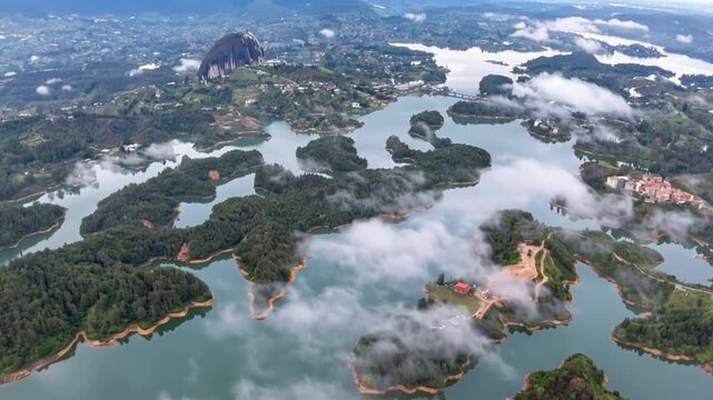 Guatap&eacute; and El Pe&ntilde;&oacute;n de Guatap&eacute; Surrounded by Reservoir Islands in Antioquia, Colombia. Time Lapse. Establishing Shot. Aerial View.
