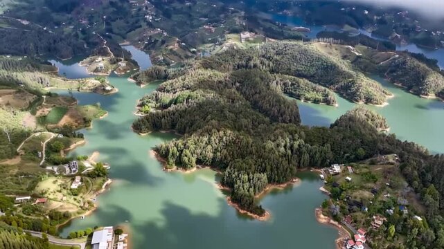 Guatap&eacute; and El Pe&ntilde;&oacute;n de Guatap&eacute; Surrounded by Reservoir Islands in Antioquia, Colombia. Time Lapse. Establishing Shot. Aerial View.