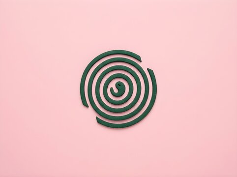 Green spiral mosquito coil on pastel pink background, minimalist flat lay concept, traditional insect repellent