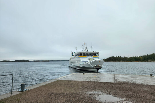 Beautiful view of ferry displaying Stockholm destination beside Baltic Sea pier on cloudy day. Sweden. Stockholm. 