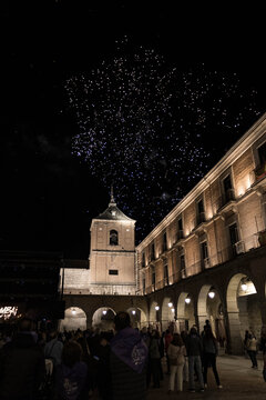 A vibrant fireworks display illuminates the night sky over the historic main square and crowd during the official opening ceremony of La Santa festival in Avila, Castile and Leon, Spain.