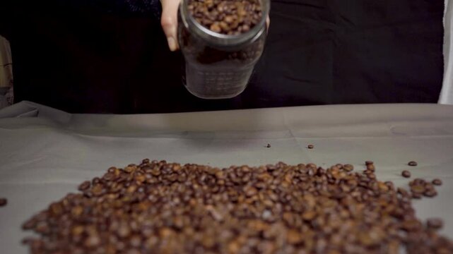Coffee Beans Spilling from a Glass Jar Close View
