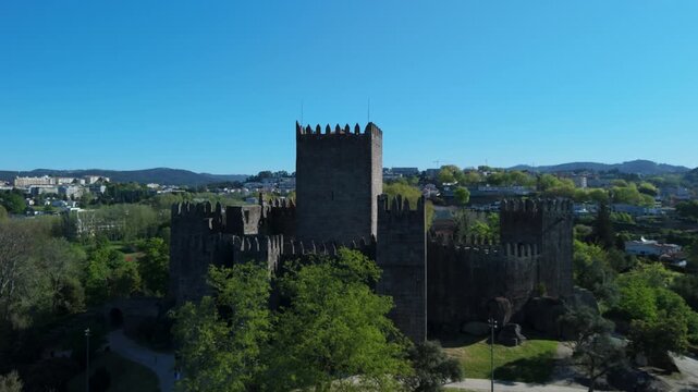 Stone Walls of Guimaraes Castle Above Green Grounds