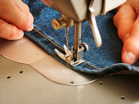 Sewing blue denim fabric on old sewing machine