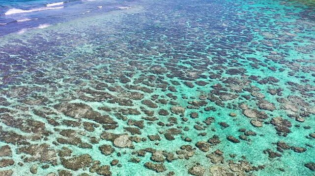 Aerial view of clear reef waters and Yoshino Beach Miyakojima Japan
