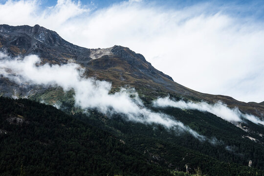 rocks with clouds on a rainy and misty day in the French Alps of Natural Parc de la Vanoise