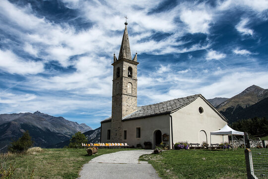 typical church with pointed tower with chairs outside for the wedding guests in the Valley of Maurienne in  the natural Parc de la Vanoise 