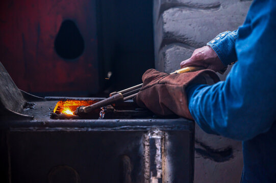 Close up unrecognizable welder repair man welding a heavy-duty container truck chassis frame, bright sparks flying during metal fabrication, industrial vehicle maintenance