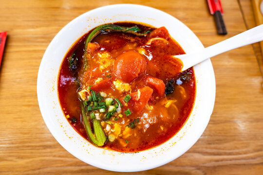 Chinese tomato egg noodles in China, a classic comfort food that combines soft scrambled eggs and a sweet-tangy tomato sauce or broth