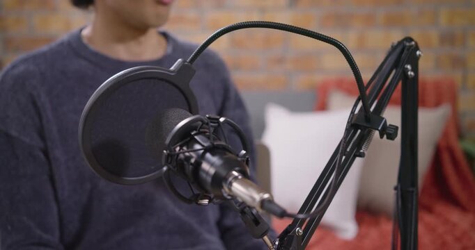 Male host and female cohost responding to condenser mic focus, speaking and gesturing on set