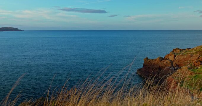 Seascape with rugged coastline at sunset in Eyemouth