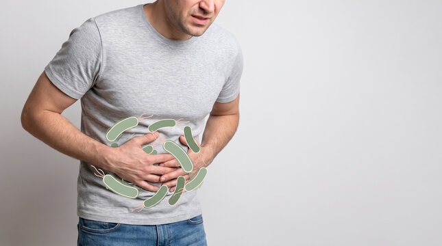 A man holding painful abdomen with green bacteria overlay showing gut infection, cramping and Digestion Diarrhea