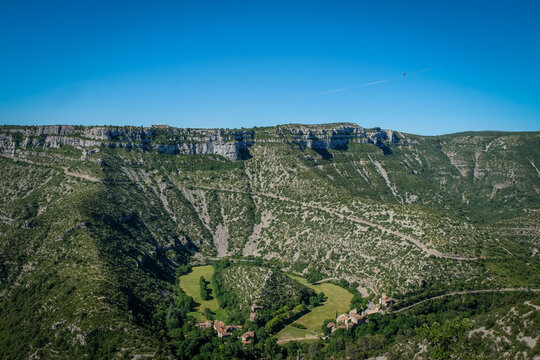 Vis river looping around the green terrace on which the hamlet stands, Cirque de Navacelles, France