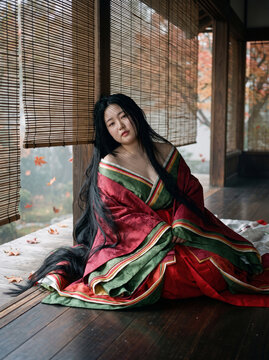 Heian period Japanese noblewoman wearing layered ceremonial silk junihitoe kimono in traditional palace