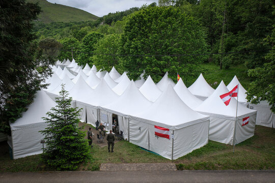 Tent camp flying national flags during the military pilgrimage in Lourdes, France