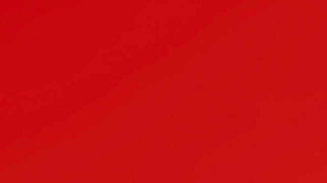 Black computer mouse cursor arrow appearing and clicking on a vibrant red background.
