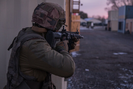French paratroopers clearing a corner in a mock village during an urban combat drill near Toulouse, France