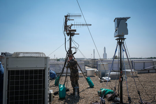Soldier watching the sky from among detection sensors during an aerospace trade fair at Le Bourget, Paris, France