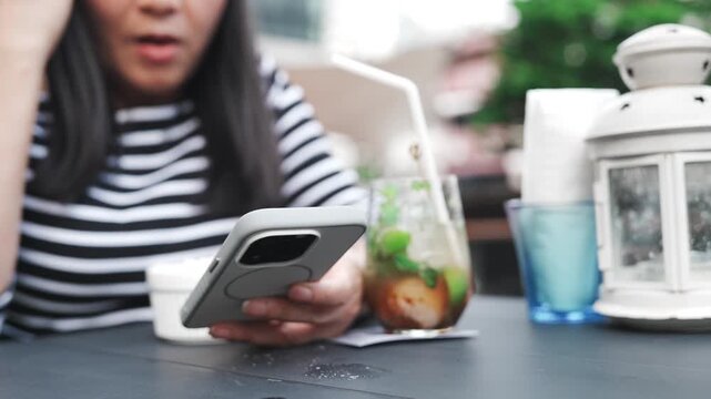 Woman eating popcorn and reading smartphone at outdoor cafe, enjoying snacks and iced drink during spring and summer leisure time, casual lifestyle, weekend relaxation and peaceful afternoon break