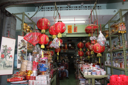 Traditional Chinese lanterns and merchandise inside a shop window