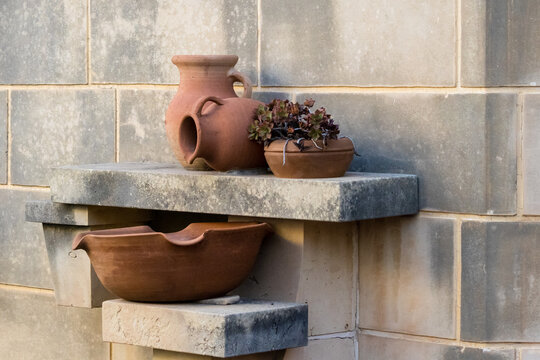 Rustic Terracotta Pots And Succulent Planter On Stone Shelf Against Tiled Wall
