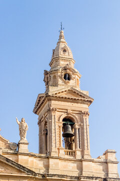 Historic Church Bell Tower and Ornate Stone Steeple Against Clear Blue Sky