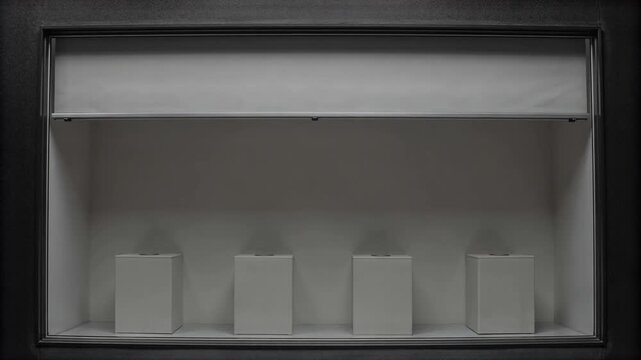 Retail window shutter lifting above empty display plinths