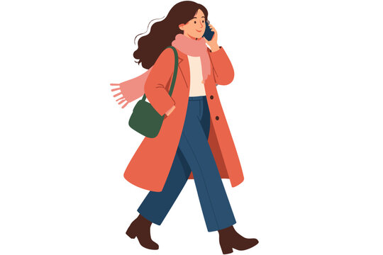 Woman walking while using a phone in a coral coat