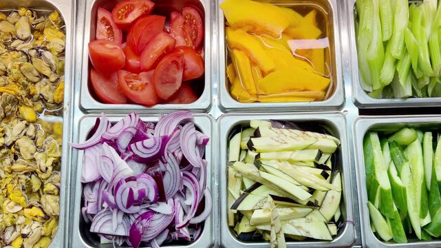 Assorted Wok Ingredients on Display in Asian Restaurant &ndash; Fresh Mushrooms, Greens, Sliced Vegetables, Various Noodles, Glass Noodles, Meatballs, Shrimp and Chicken for Custom Stir-Fry