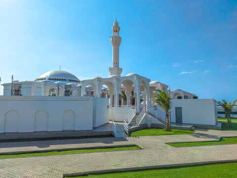 Al Rahmah Mosque, also known as Floating Mosque, stands elegantly over Red Sea waters along Jeddah Corniche in Saudi Arabia, presenting beautiful landmark for worship and tourism under a bright sky