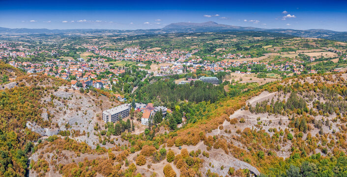 Aerial panorama of a Balkan town Sokobanja nestled between forested hills and Rtanj mountain valley - ideal for regional tourism in Serbia