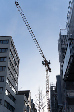 Tower Crane Between Buildings at Urban Construction Site