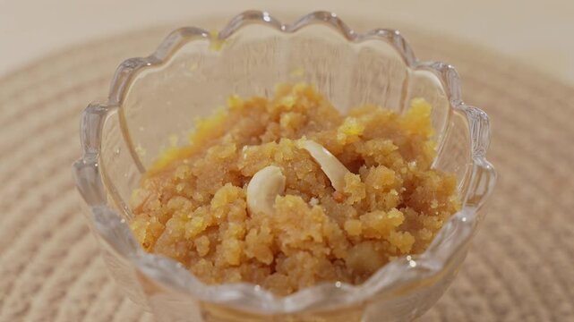 Rich Golden Moong Dal Halwa Slow Cooked in Ghee and Garnished with Chopped Nuts, Traditional Indian Dessert Close-Up.