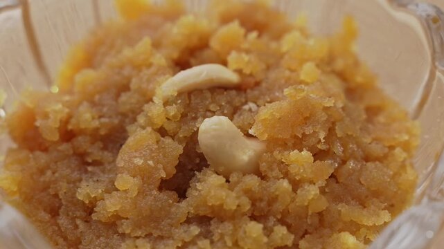 Rich Golden Moong Dal Halwa Slow Cooked in Ghee and Garnished with Chopped Nuts, Traditional Indian Dessert Close-Up.