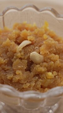 Rich Golden Moong Dal Halwa Slow Cooked in Ghee and Garnished with Chopped Nuts, Traditional Indian Dessert Close-Up.