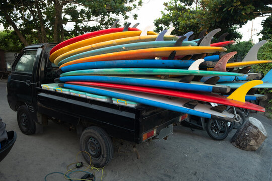 Surfboards stacked up on small truck