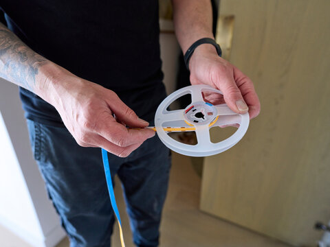 Electrician Unravelling LED Lighting Cable