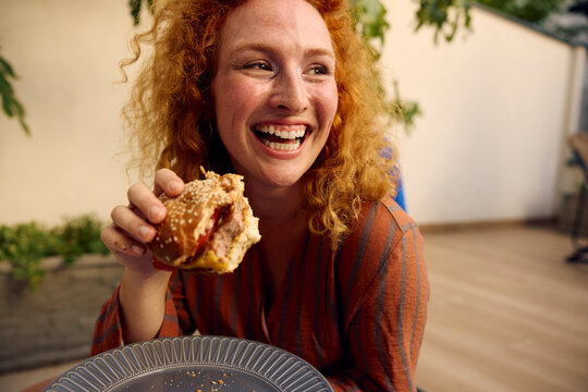 Woman Enjoys a Homemade Burger