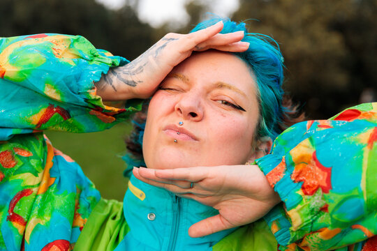 Young woman in colorful outfit making gestures