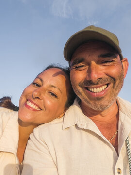 Happy couple smiling together during summer trip