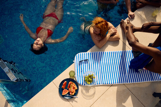 Friends hanging out in the pool