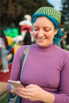 Young woman checking phone outdoors