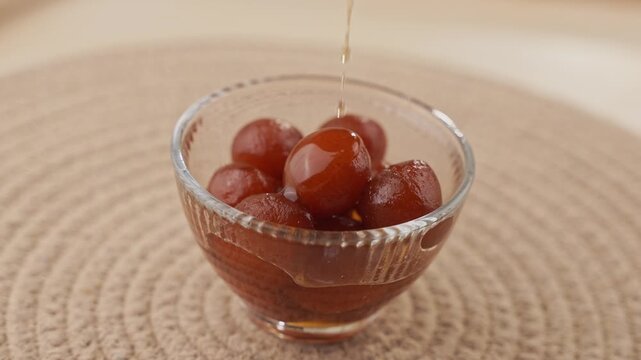 Soft Bite-Sized Mini Gulab Jamun Soaked in Warm Sugar Syrup, Traditional Indian Dessert Close-Up Shot