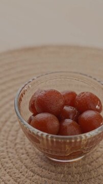 Soft Bite-Sized Mini Gulab Jamun Soaked in Warm Sugar Syrup, Traditional Indian Dessert Close-Up Shot