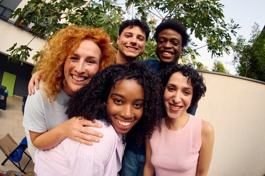 Friends gather for a portrait in the backyard.